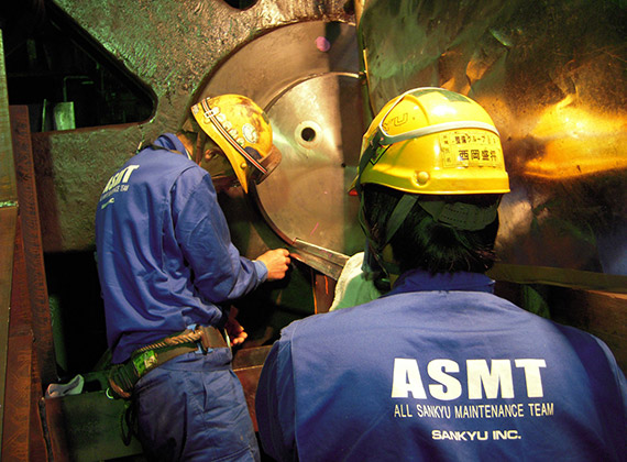 Plant worker making an adjustment on equipment