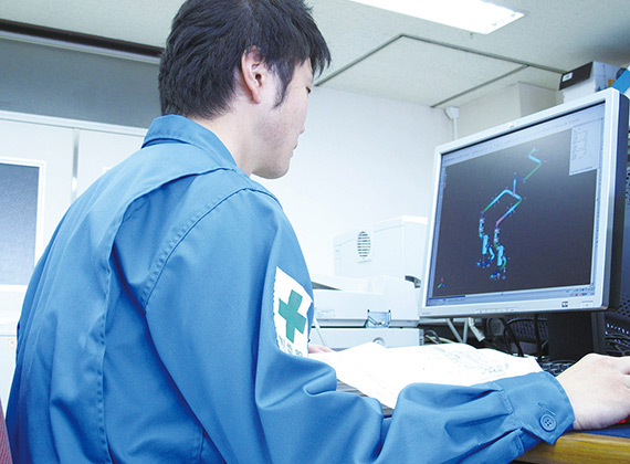 Worker looking at cmputer screen with CAD drawing