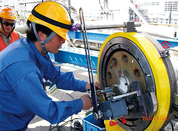 Plant worker making an adjustment on equipment